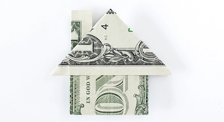 A dollar folded in a house shape