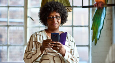 A woman holding a smart phone